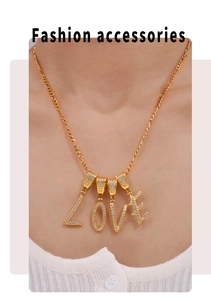 Detailed view of gold plated LOVE letter pendant with micro paved cubic zirconia stones