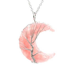 Detail of rose quartz crescent moon pendant with silver wire-wrapped tree of life design