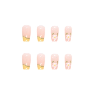 Floral press-on nails with yellow French tips and green leaf patterns in long coffin shape