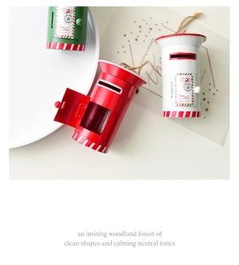 Close-up of red, white, and green mini Christmas mailbox ornaments with rustic hemp rope