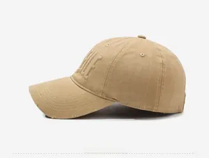 Close-up of distressed brim details and 3D letter embroidery on khaki baseball cap