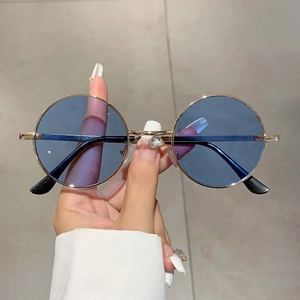 Gros plan de lunettes de soleil rondes rétro avec verres bleus et strass en cœur