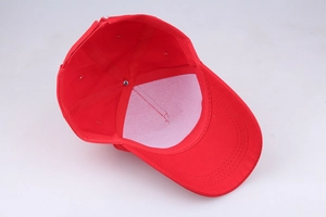 Internal view of red cotton baseball cap showing detailed stitching and white front lining