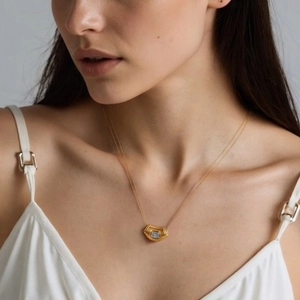 Gold stainless steel geometric teardrop necklace with square zircon on a model