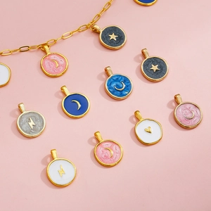 Macro view of colorful enamel alloy charms with star moon and heart designs on pink background