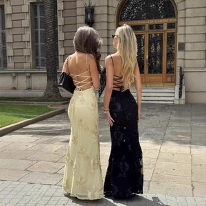 Elegant backless floral embroidery gown with lace-up details in a classic setting