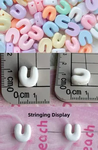 Detailed view of 10mm macaron resin beads with scale measurement for DIY jewelry making