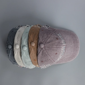 Detail view of washed cotton baseball caps in multiple colors with healthy embroidery