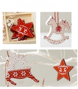 Detailed view of red and white wooden Christmas ornaments with reindeer and star patterns