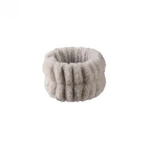 Detailed close-up of soft grey coral fleece wristband showing absorbent plush texture