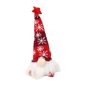 Lighted Christmas gnome doll with red snowflake knit hat and star topper on white background
