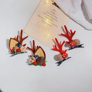 Christmas antler hair clips with pine cones and berries in festive holiday setting