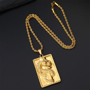 Gold plated dragon pendant necklace with twisted rope chain on black background