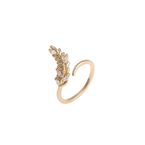 Detailed macro view of gold olive leaf ring with sparkling micro-inlaid zirconia stones