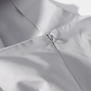 Macro shot of invisible zipper and fine diagonal texture on light grey suit jacket back
