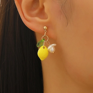 Sweet yellow lemon and white flower earrings with green leaf pendants on female model