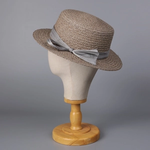 Flat top raffia sun hat for women with grey silk ribbon bow on mannequin stand