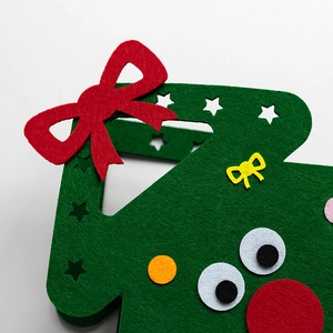 Creative green Christmas felt gift bag with festive red bow and handmade details