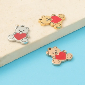 Detail of silver and gold stainless steel bear charms with red hearts for DIY jewelry