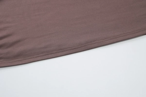 Détail de la texture en maille marron et coutures de qualité sur cette robe d'été