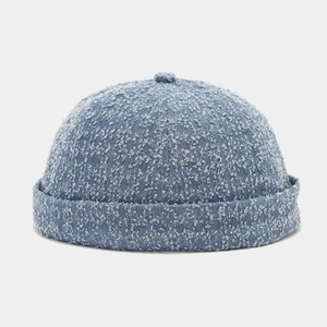 Detail view of light blue docker cap featuring textured denim tweed fabric and minimalist design