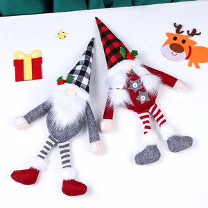 Close-up of handmade Christmas gnome curtain tiebacks with knitted hats and long legs