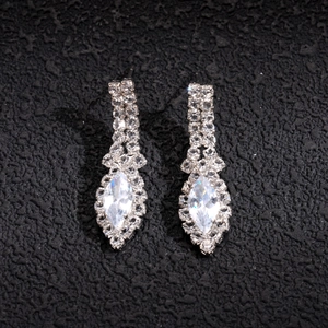 Close-up of silver long tassel earrings with marquise-cut rhinestones and elegant fringe