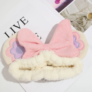 Soft plush floral embroidery headband with large pink bow for skincare and washing face