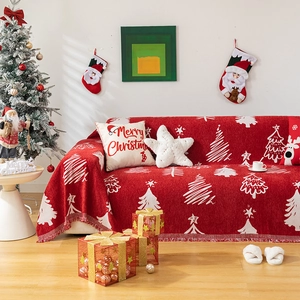 Christmas red sofa throw blanket with white knit trees and festive decor in cozy living room