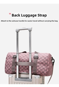 Detail of travel duffel bag showing back strap secured on luggage handle.
