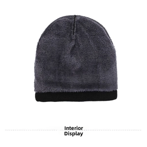 Detailed view of the thick gray fleece lining inside a black winter knit beanie