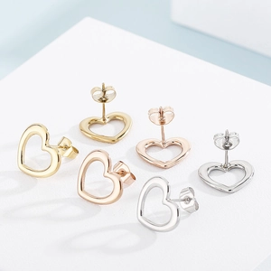 Three pairs of hollow heart stud earrings in gold, rose gold, and silver stainless steel