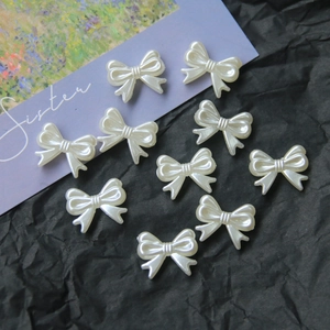 Macro detail of pearlescent butterfly DIY charms for jewelry making on dark background