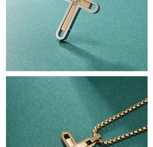 Detailed macro view of silver and gold plated studded cross necklace with box chain