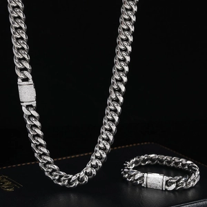 Detail of 12mm Cuban link chain with zircon micro-pave clasp on a leather display stand