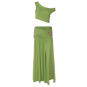 Detail of grass green two-piece set featuring one-shoulder crop top and long skirt with floral trim