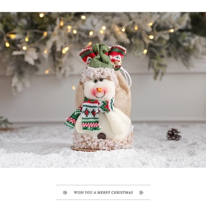 Detailed view of snowman Christmas gift bag with striped scarf and drawstring closure