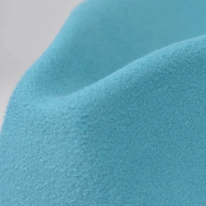 Macro shot of sky blue felt texture showing high-density wool material and fine fibers
