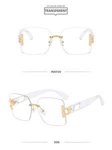 Detail of square rimless sunglasses with gold metal frame and transparent lenses