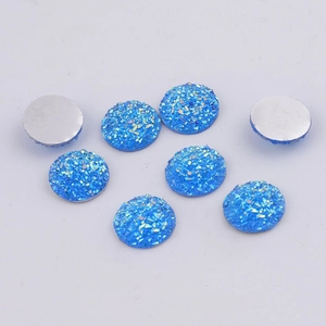 Close-up of 14mm blue glitter resin cabochons with flat silver back for DIY jewelry