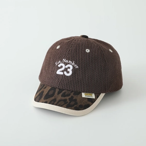 Close-up of knit texture and leopard print brim on children baseball cap with 23 embroidery