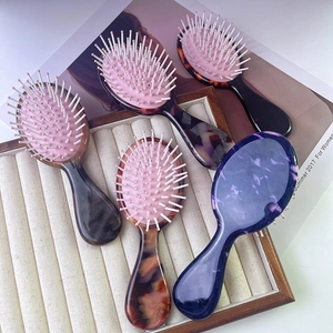 Portable acetate hair brushes with marble patterns and soft pink air cushions for head massage