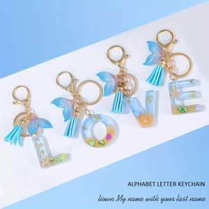 Blue ocean-themed LOVE alphabet letter keychain set with mermaid tail and tassels