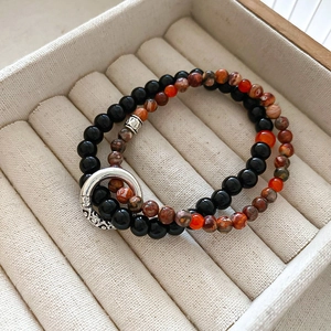Detail of double-layer beaded bracelet with lily of the valley stones and silver ring