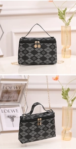Detail of clover print handbag with gold double zippers and quilted argyle pattern texture