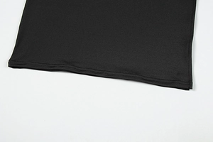 Close-up of the double-needle stitched hem and smooth fabric of the black dress