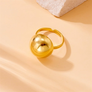Macro shot of polished gold-plated sphere ring with an adjustable open band detail