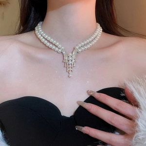 Close-up of elegant double-layer pearl and rhinestone necklace worn by a model