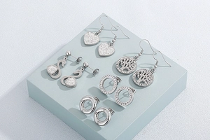 Detailed set of 5 silver stainless steel earrings featuring heart, swan, and tree of life
