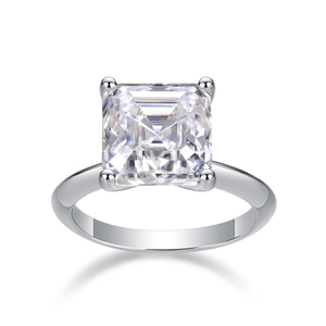Macro detail of princess cut moissanite ring with classic four-prong setting and silver band